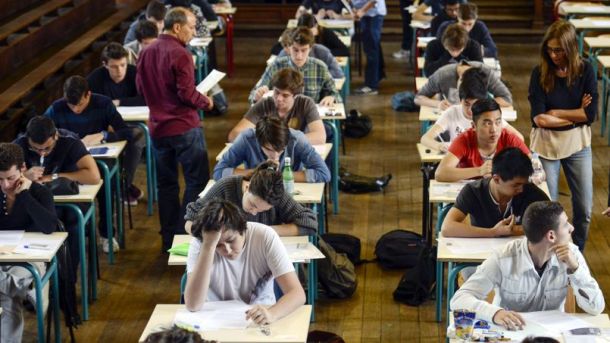French students work on the test of philosophy as they take the baccalaureat exam (high school graduation exam) on June 16, 2014 at the Jacques Decour high school in Paris.  AFP PHOTO / FRED DUFOUR